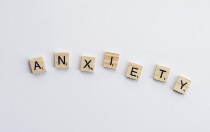 Wooden cubes with letters that make the word 'anxiety'.